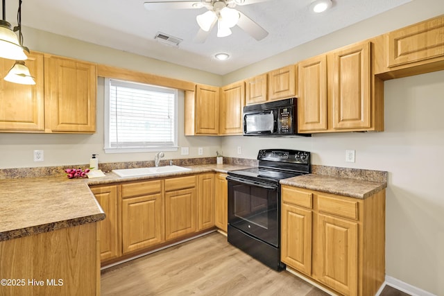 kitchen with visible vents, light brown cabinets, black appliances, a ceiling fan, and a sink