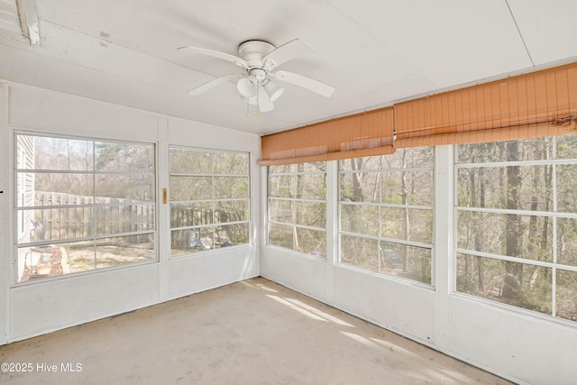 unfurnished sunroom featuring a ceiling fan