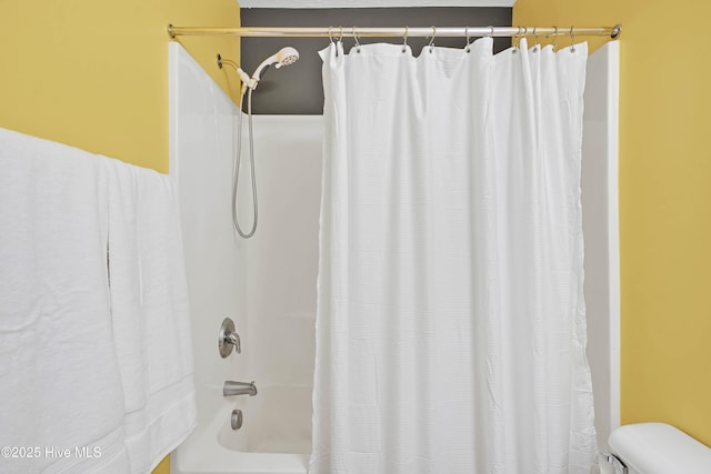 full bathroom with shower / bath combo with shower curtain and toilet