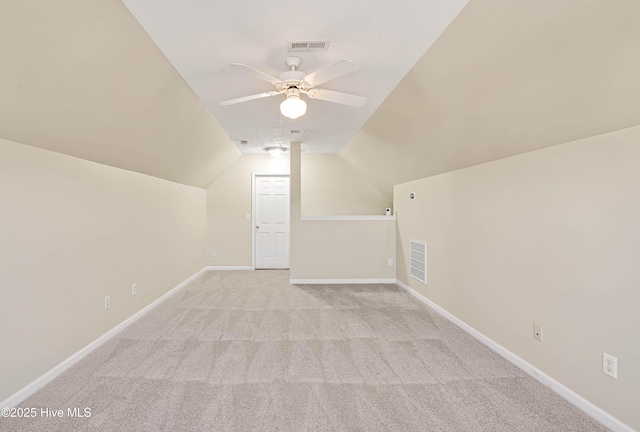 additional living space featuring visible vents, baseboards, ceiling fan, lofted ceiling, and carpet flooring