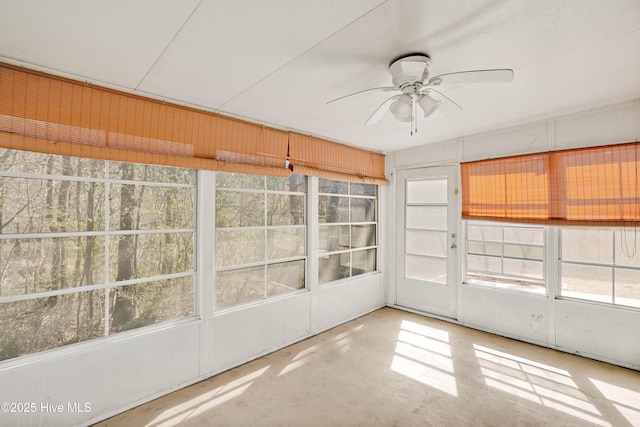 unfurnished sunroom featuring ceiling fan