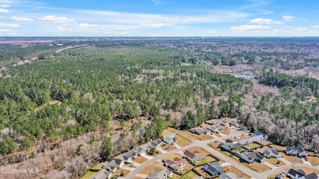 birds eye view of property with a residential view and a wooded view