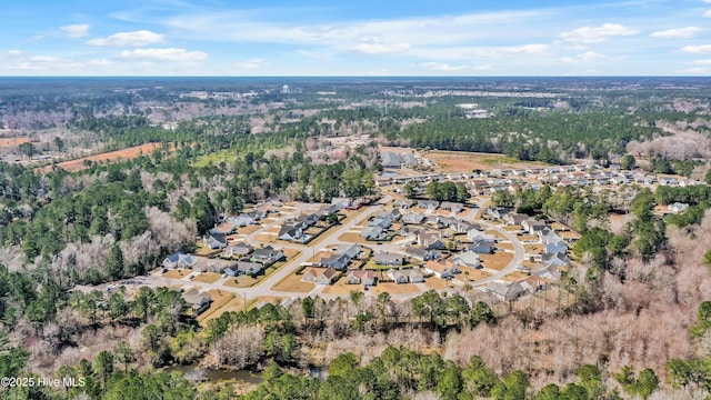 drone / aerial view with a residential view and a view of trees