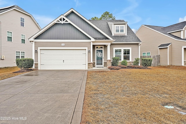 craftsman inspired home featuring a garage and a front lawn