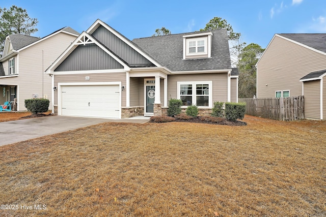 craftsman inspired home featuring a front yard and a garage