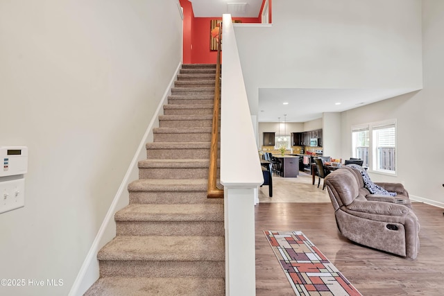 2306 Cottagefield Ln, Leland, NC 28451 - staircase featuring hardwood / wood-style floors and a towering ceiling