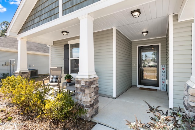 property entrance featuring covered porch and central air condition unit