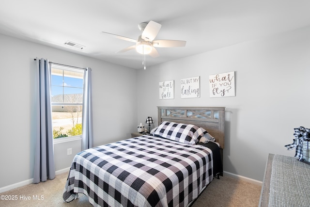 bedroom featuring baseboards, ceiling fan, visible vents, and light colored carpet