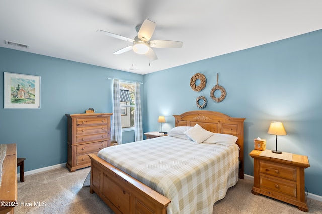 bedroom with light colored carpet, visible vents, and baseboards