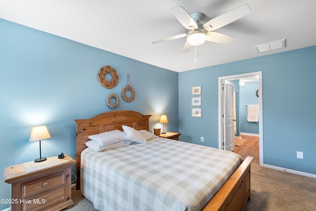 carpeted bedroom featuring baseboards, visible vents, and ceiling fan