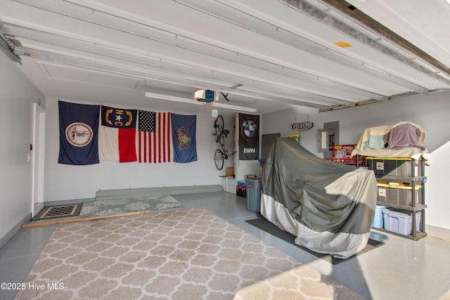 garage featuring a garage door opener, electric panel, and baseboards