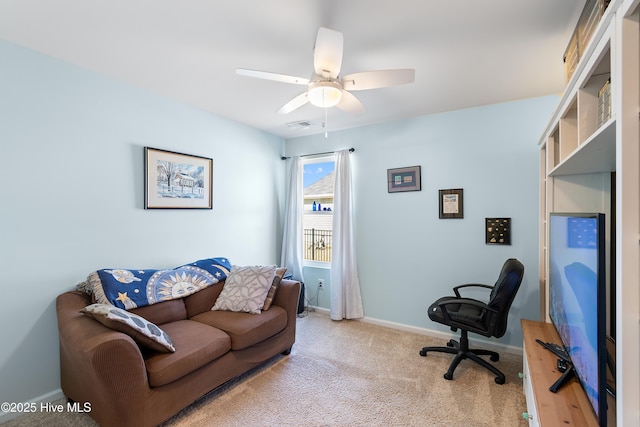 carpeted office space featuring visible vents, ceiling fan, and baseboards