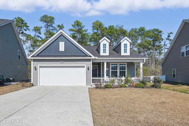 view of front of house featuring a shingled roof, concrete driveway, an attached garage, a porch, and board and batten siding