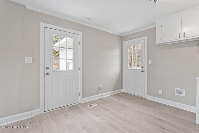 entryway featuring ornamental molding, light hardwood / wood-style floors, and a wealth of natural light