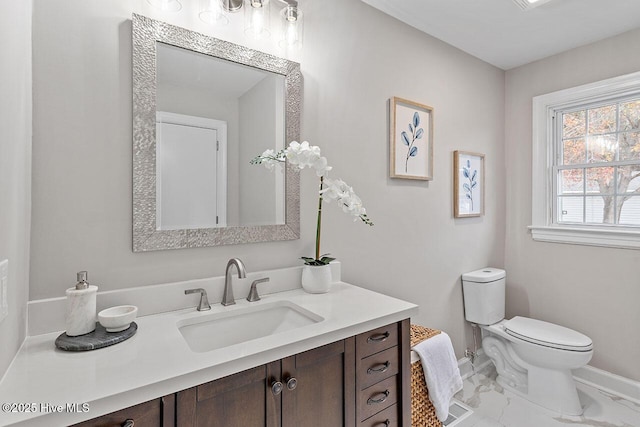 bathroom featuring vanity and toilet