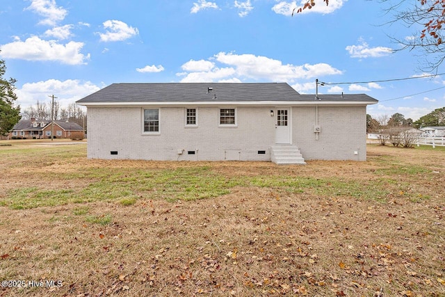 rear view of property with a lawn