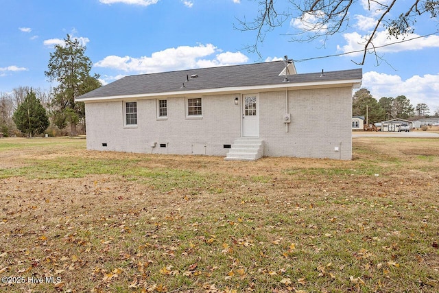 back of property featuring a yard