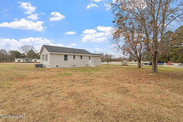 rear view of property with a lawn