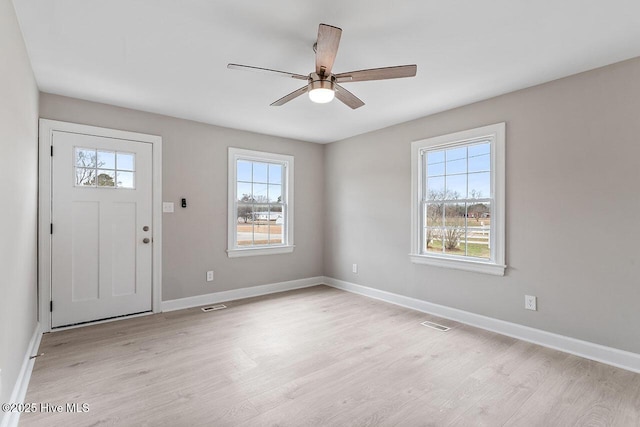 entrance foyer featuring ceiling fan, light hardwood / wood-style floors, and a healthy amount of sunlight