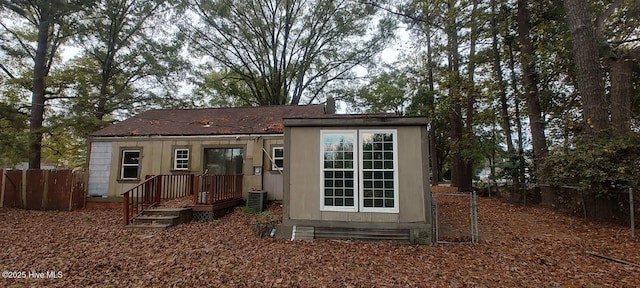 view of outbuilding with cooling unit and fence