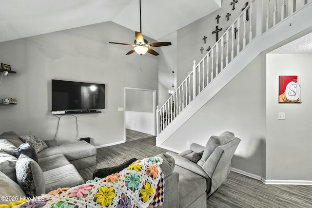 living area featuring high vaulted ceiling, ceiling fan, baseboards, and stairs