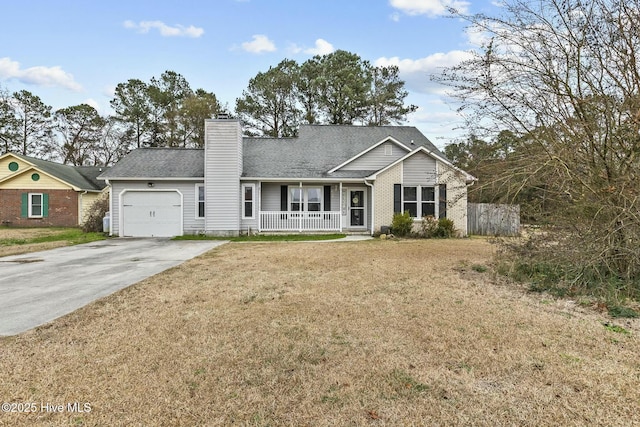 view of front of property with a garage, a front yard, and covered porch