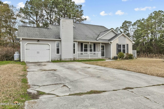 view of front of house with a garage, a front yard, and covered porch