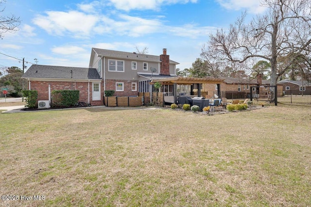 rear view of property with a chimney, a lawn, a patio area, fence, and a pergola