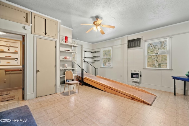 interior space featuring heating unit and a textured ceiling