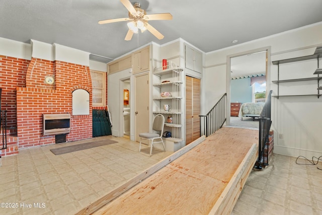 interior space featuring heating unit, a fireplace, and ceiling fan