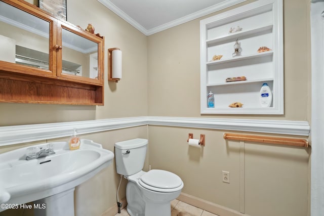 bathroom featuring crown molding, tile patterned floors, toilet, and sink