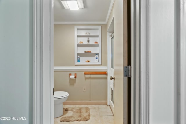 bathroom featuring built in features, tile patterned floors, crown molding, and toilet