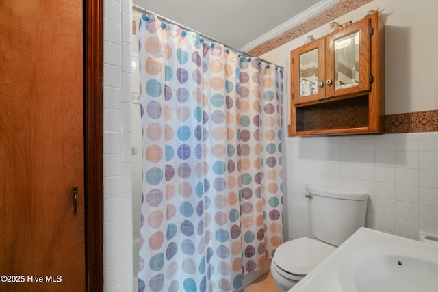 bathroom featuring tile walls, ornamental molding, toilet, and walk in shower