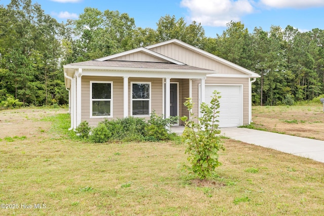 view of front of house featuring a garage, covered porch, and a front yard