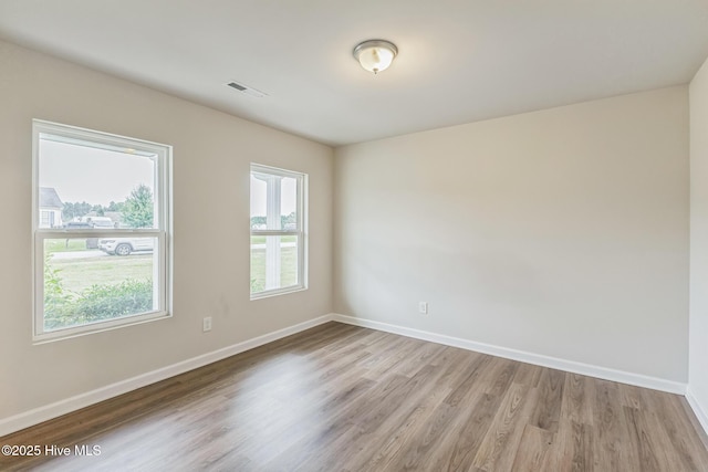 unfurnished room with light hardwood / wood-style floors