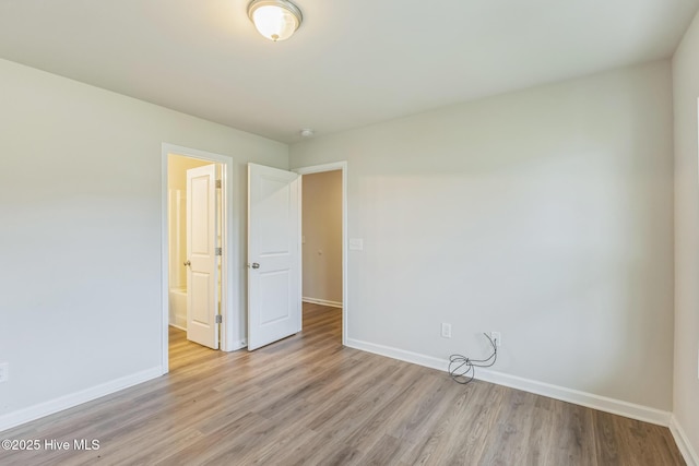 empty room with light hardwood / wood-style flooring