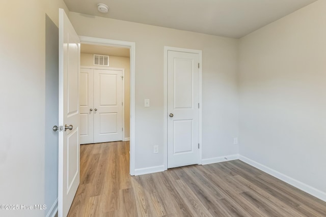 unfurnished bedroom featuring light wood-type flooring