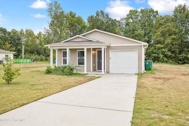 view of front of house featuring a garage, a front lawn, and covered porch