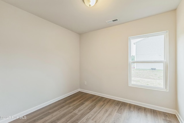 spare room with wood-type flooring