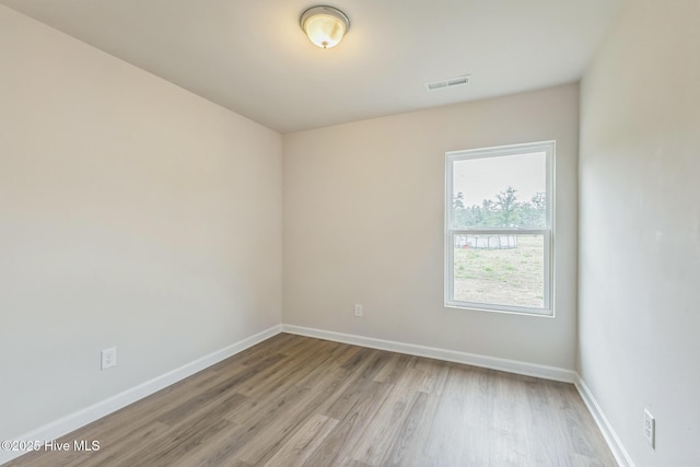 empty room with light hardwood / wood-style flooring