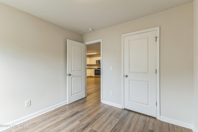 unfurnished bedroom with light hardwood / wood-style floors