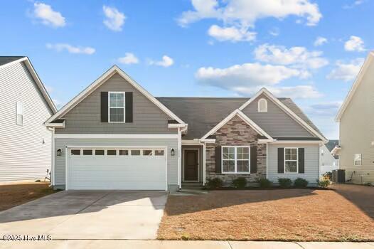 craftsman-style house featuring a garage and central AC unit