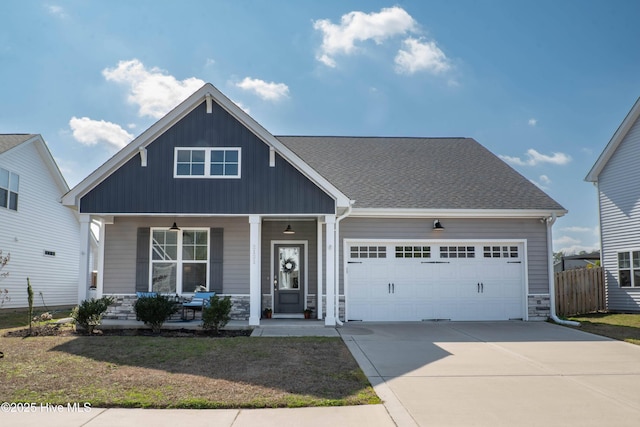 craftsman house with a porch and a garage