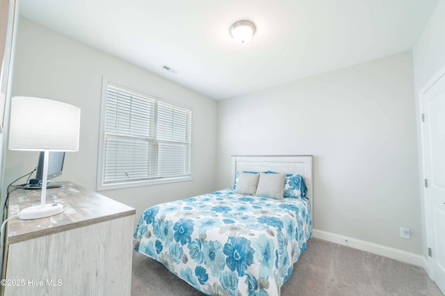 bedroom featuring light colored carpet