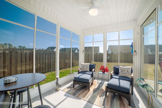 sunroom with a healthy amount of sunlight and ceiling fan