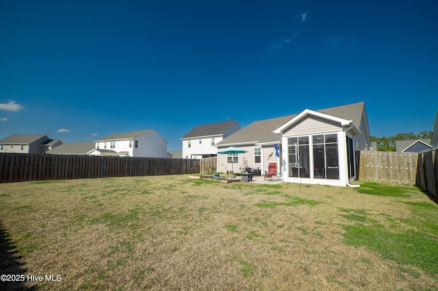 rear view of property featuring a patio and a lawn