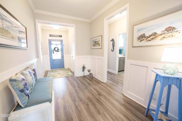 foyer entrance featuring ornamental molding and wood-type flooring