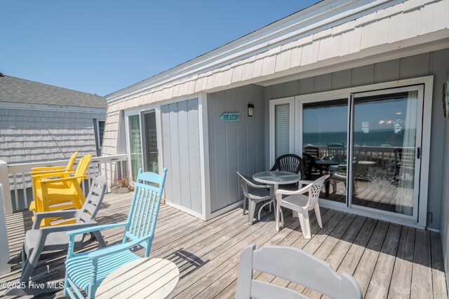 wooden terrace with outdoor dining area