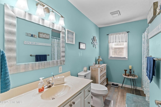 169 NW 7th St, Oak Island, NC 28465 - bathroom with wood finished floors, toilet, and vanity