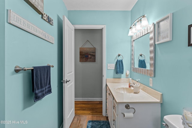 169 NW 7th St, Oak Island, NC 28465 - bathroom with toilet, wood finished floors, and vanity